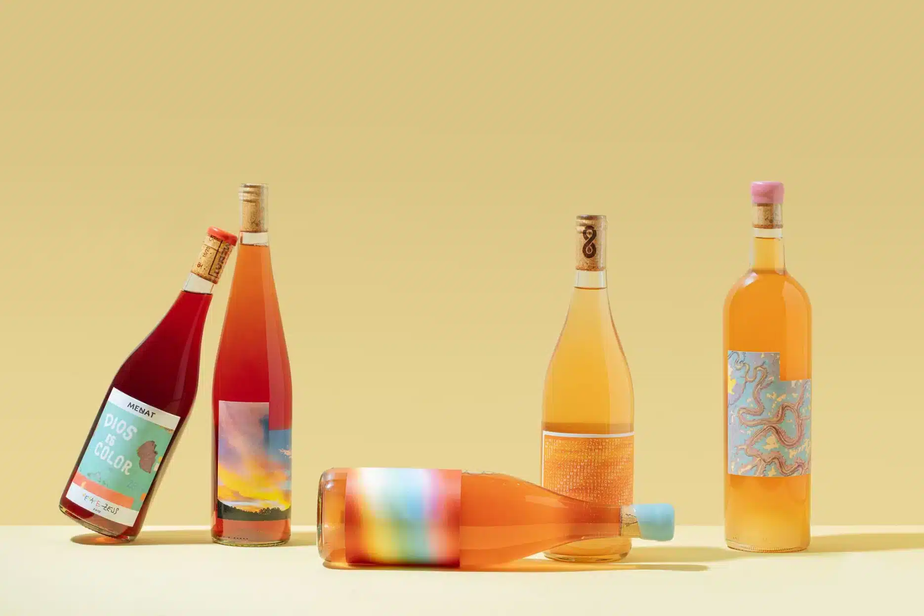 A selection of orange wine bottles beautifully arranged, showcasing their rich amber hues and artisanal labels.
