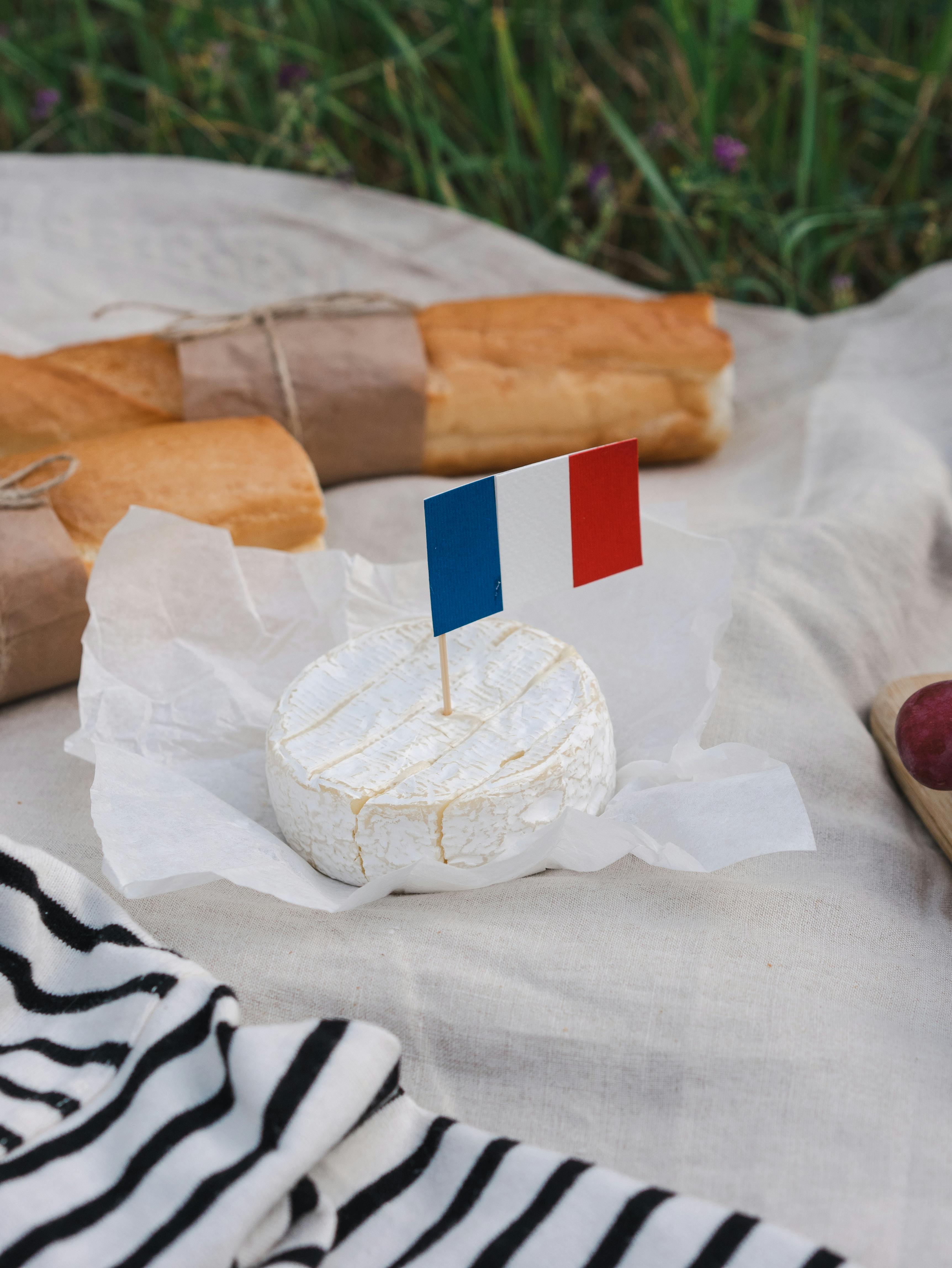 Camembert with a french flag. The ultimate cheese tasting experience in paris. Located in Montmartre and created by a passionate french cheesemonger.